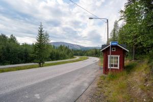 a small red building on the side of a road at Compact Cabin for Remote Work and Adventures in Yllas in Ylläsjärvi +2 photos
