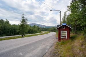 a red building on the side of a road at Basecamp in Yllas for Adventures in Ylläsjärvi
