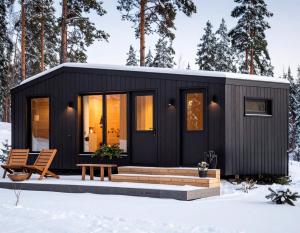 a black tiny house in the snow at Basecamp in Yllas for Adventures in Ylläsjärvi