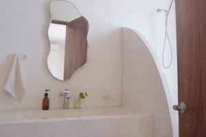 a bathroom with a mirror and a sink at Sayulita beach-side studio 2 by CasasTropical in Sayulita +26 photos