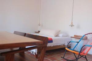 a bedroom with a bed and a rocking chair at Sayulita beach-side studio 2 by CasasTropical in Sayulita