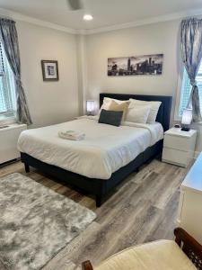a bedroom with a large bed and two windows at 20N - Stylish 1BD 1BA Condominium in the Heart of Downtown in Atlanta +29 photos