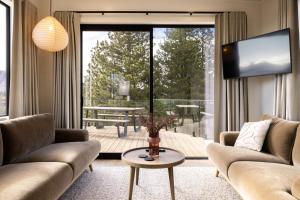 a living room with two couches and a large window at The Alpine 2-Bedroom Villa - Roam Lake Tekapo in Lake Tekapo