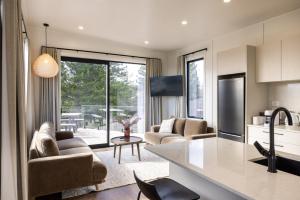 a kitchen and living room with a view of a patio at The Alpine 2-Bedroom Villa - Roam Lake Tekapo in Lake Tekapo