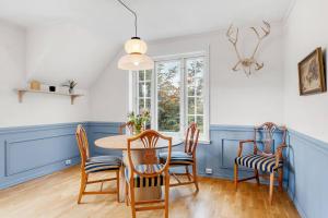 a dining room with a table and chairs at Arctic hilltop lodge - Room 3 in Guleng