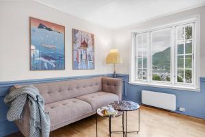 a living room with a couch and two windows at Arctic hilltop lodge - Room 3 in Guleng