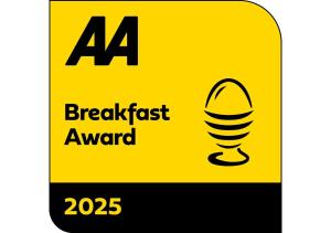 a yellow sign that reads breakfast award with a microphone at Beinn Bhracaigh in Pitlochry
