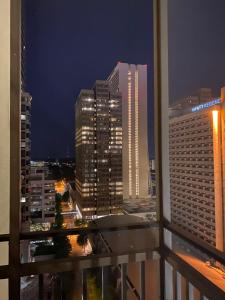 a view of a city at night from a balcony at 8th Floor Stylish Downtown Condo Private Balcony in Atlanta