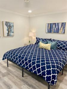 a bedroom with a bed with a blue and white comforter at 8th Floor Stylish Downtown Condo Private Balcony in Atlanta +55 photos