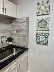a kitchen with a sink and a tile wall at Cozy 2BR 2BA in Downtown Atlanta in Atlanta +13 photos