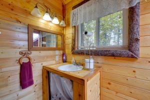 a bathroom with a sink and a mirror at Ultimate Alaskan Retreat Lakefront Soldotna Cabin in Ridgeway +18 photos