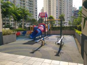a playground with a slide in a city at Camellia Serviced Suites in Kuala Lumpur