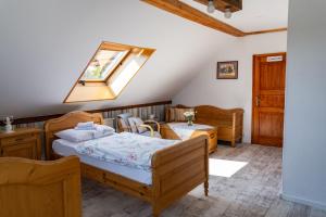 a bedroom with two beds and a skylight at Klimbergowice in Sztum