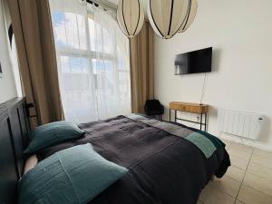 a bedroom with a bed and a large window at Blue dream in Carantec