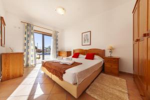 a bedroom with a large bed with red pillows at B36 - Dona Ana Secluded Spot in Lagos +82 photos