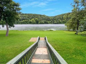 a bridge over a field with a view of a lake at Riverfront Retreat - Right next to the White River in Norfork