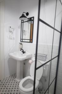 a bathroom with a white toilet and a sink at Citadelle house in Alba Iulia
