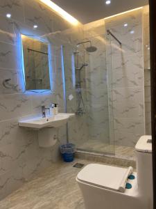 a bathroom with a toilet and a sink and a shower at haya abdun in Amman +7 photos