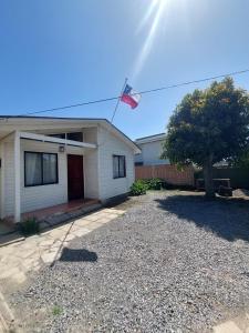 a house with a flag in the front of it at Cabaña Independiente para 4 personas con estacionamiento in Santo Domingo +13 photos