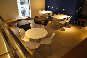 a group of tables and chairs in a room at Urban L in São Paulo +11 photos