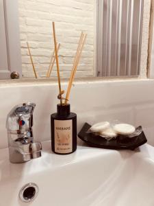 a bathroom sink with a candle and chopsticks on it at Hotel La Morada in Treinta y Tres