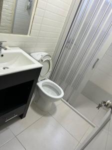 a bathroom with a toilet and a sink and a shower at Hotel La Morada in Treinta y Tres