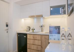 a kitchen with a sink and a counter with water bottles at Seaside Studio 1BR near the Malecon in Miraflores in Lima