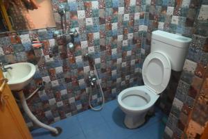 a bathroom with a toilet and a sink at Kashi Vibes Hostel in Varanasi +24 photos
