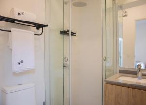 a bathroom with a shower and a toilet and a sink at Seaside Studio 1BR near the Malecon in Miraflores in Lima