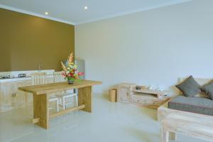 a living room with a table and a couch at Villa Padma Ubud in Ubud