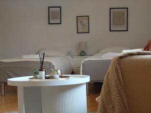a living room with two beds and a white table at Vista in Vaasa