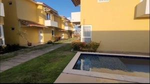 a house with a swimming pool in a yard at Elaine Graziela in Pitimbu