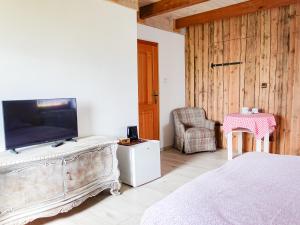 a bedroom with a bed and a flat screen tv at Klimbergowice in Sztum