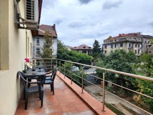 a balcony with a table and chairs on a balcony at The Nomads Nest - Old Town in Bucharest
