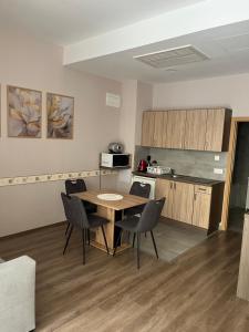 a kitchen with a table and chairs in a room at Solaris Apartman in Zalakaros