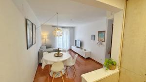 a living room with a white table and chairs at Nomad Haux Tossa de Mar 12 in Tossa de Mar