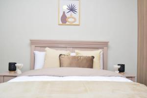 a bedroom with a large bed with white sheets and pillows at House For Six Adults in Witbank