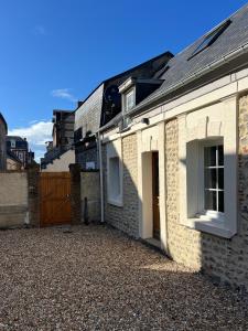 a brick house with a gate and a driveway at Yport - Normandy - Casa Eterea 5 in Yport