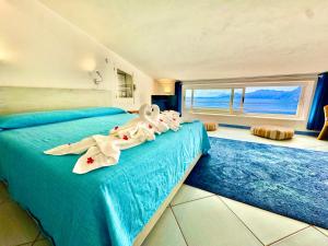 En eller flere senge i et værelse på La Mansarda