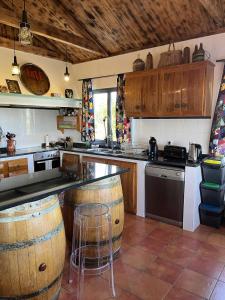 a kitchen with a counter and some wooden cabinets at Casa Fitz - Bungalow with Ocean Views and Air Conditioning in Santa Luzia