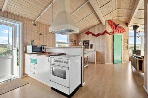 a kitchen with a stove and a white oven at FAN076-Fano-Slunden-123 in Fanø