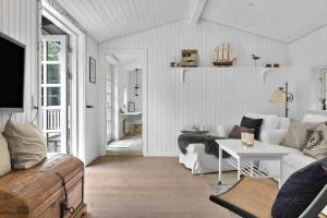 a living room with a couch and a table at 1183-N-Frederiksvaerk-Plovvaenget-6 in Asserbo