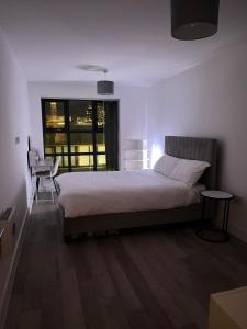 a bedroom with a large bed and a window at Birmingham City Center View in Birmingham