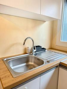 eine Küche mit Spüle und Herd in der Unterkunft Maison avec Terrasse 6 pax proche Paris & Disney - Parking in Nogent-sur-Marne