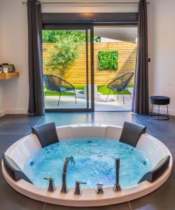 a jacuzzi tub in a living room at Nuit confort avec Balnéo XXL privative et Climatisation in Nantes