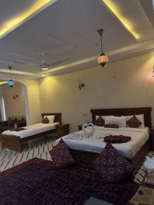 ein Hotelzimmer mit zwei Betten und einem Spiegel in der Unterkunft Hotel Pearl Regency in Kalām + 24 Fotos