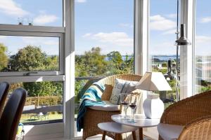 a balcony with a table and chairs and windows at LF14058-Roslev-Eskovvej-58 in Flovtrup