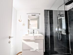a white bathroom with a sink and a shower at Casa Lairesse in Liège +22 photos