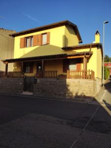 a yellow house on the side of a street at La Coccinella in Canale Monterano +2 photos
