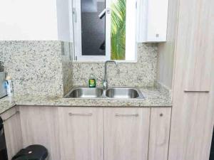a kitchen counter with a sink and a window at Cozy Apartment near Downtown Center in Santo Domingo +42 photos